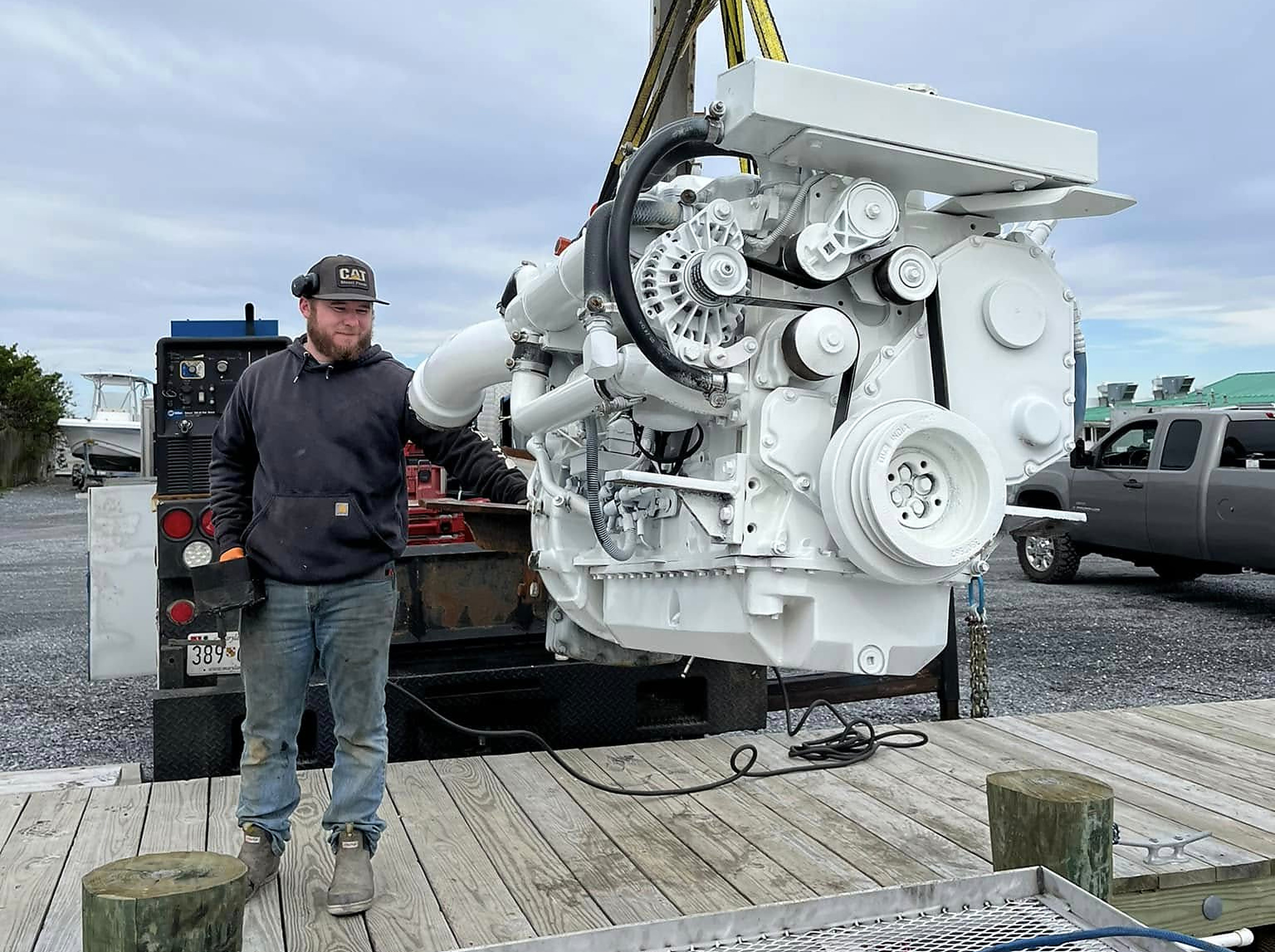 A marine diesel engine on the crane at the dock
