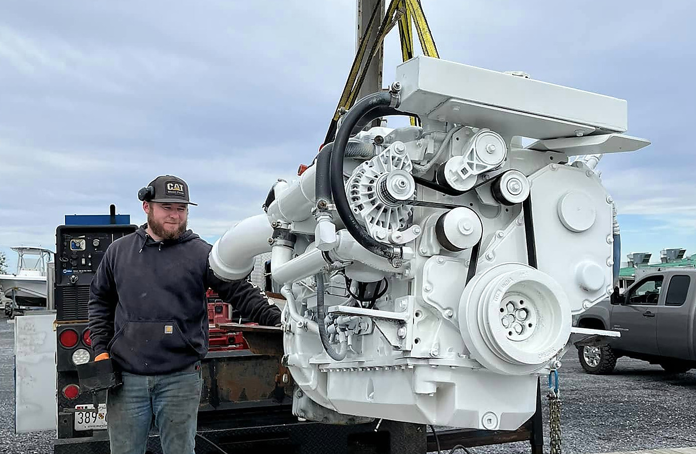A marine diesel engine on the crane at the dock
