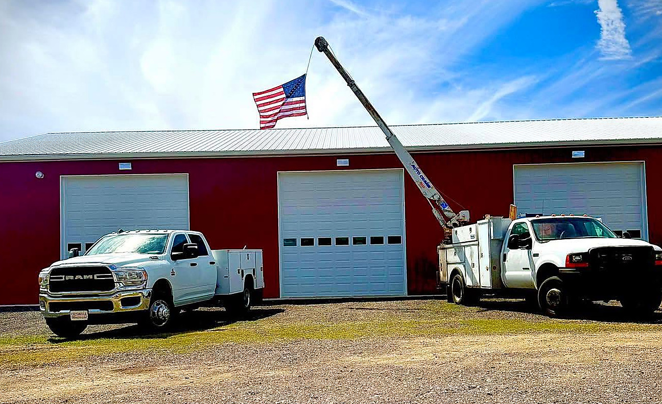 The red Faith Driven Diesel shop building with the flag flying