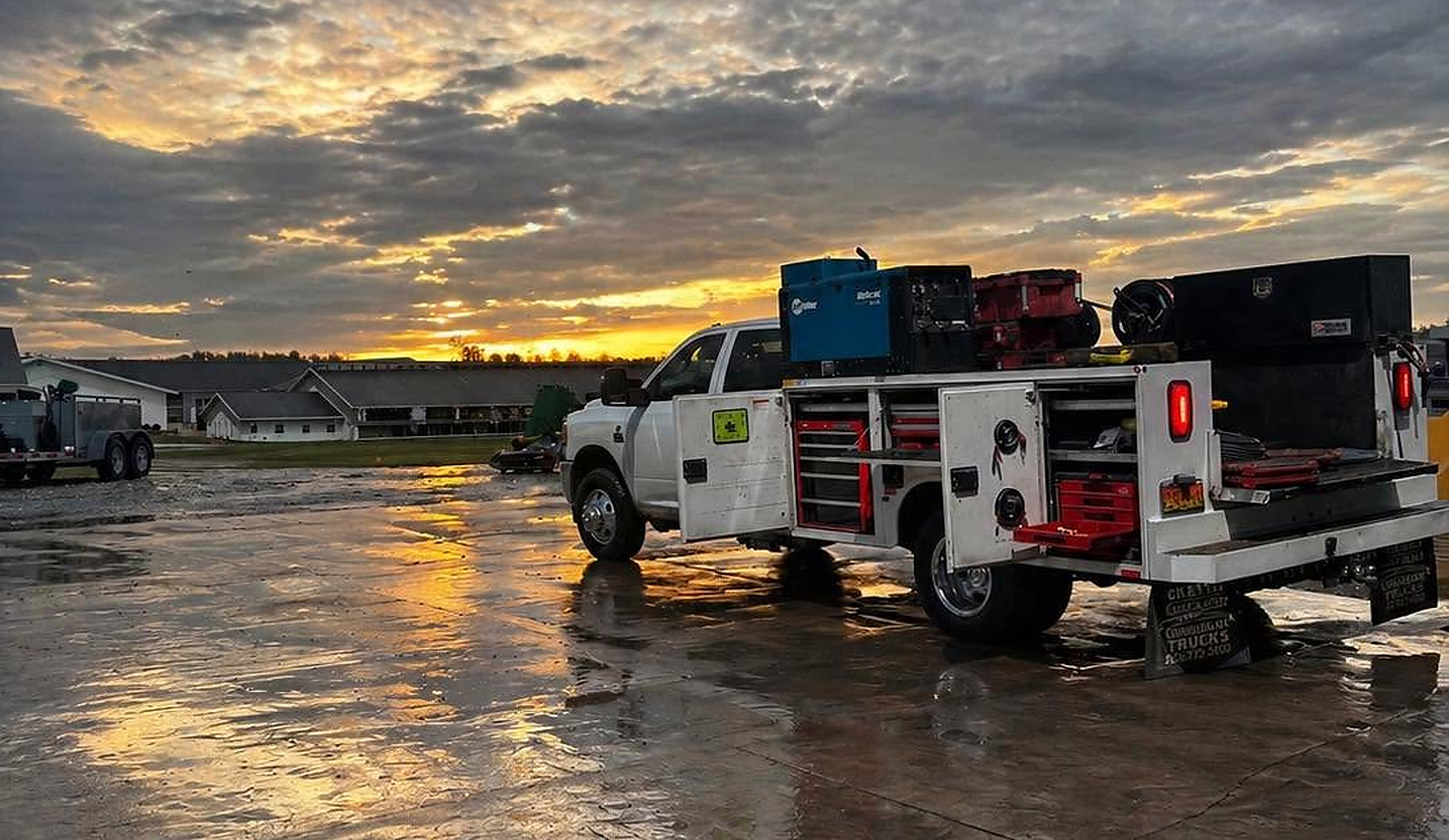 The Faith Driven service truck on a wet lot at sunset